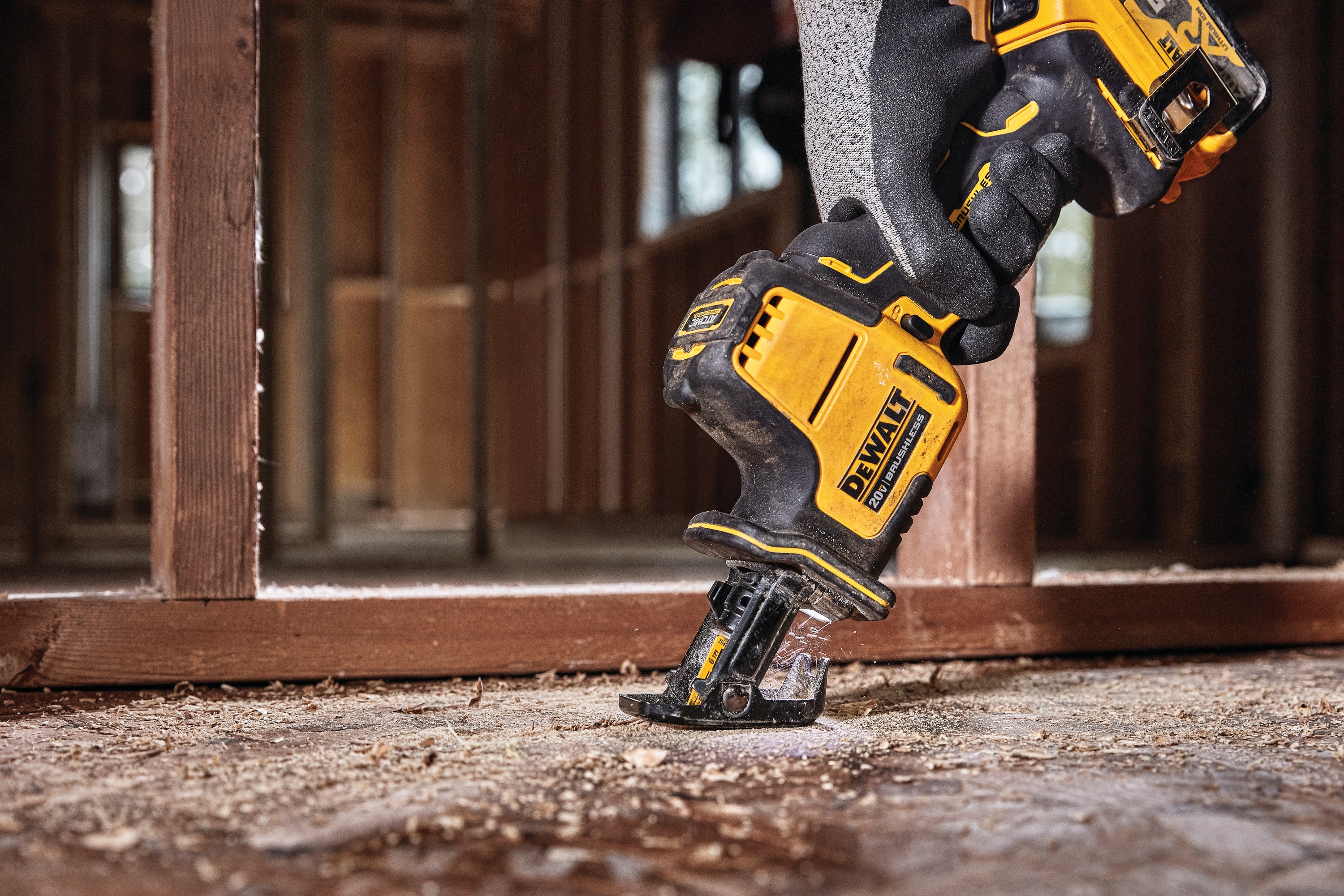 Close up shot of Cordless One Handed Reciprocating Saw being used on wooden floor 
