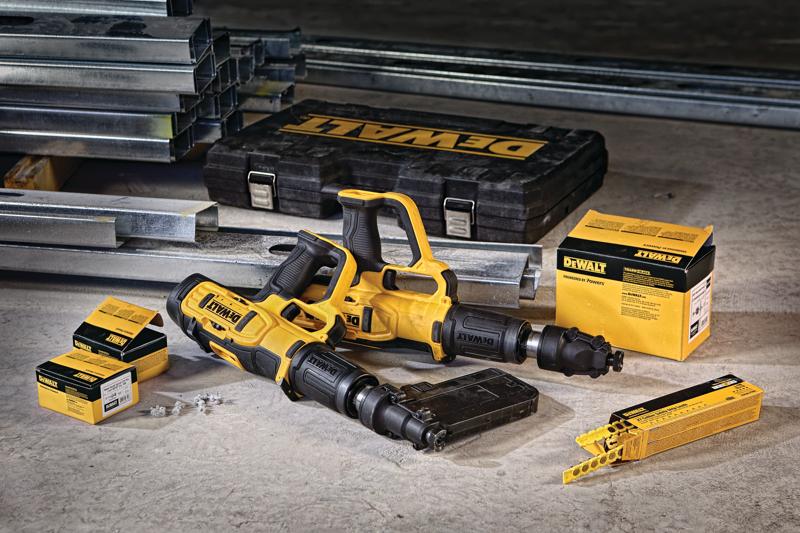 A set of DEWALT DFD270SK tools, including two yellow and black powder-actuated fastening systems, a DEWALT branded carrying case, boxes of fasteners, and steel beams on a concrete floor.